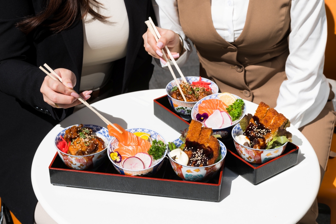Image of two bento boxes, with three dishes - chicken katsu, salmon sashimi and teriyaki chicken don