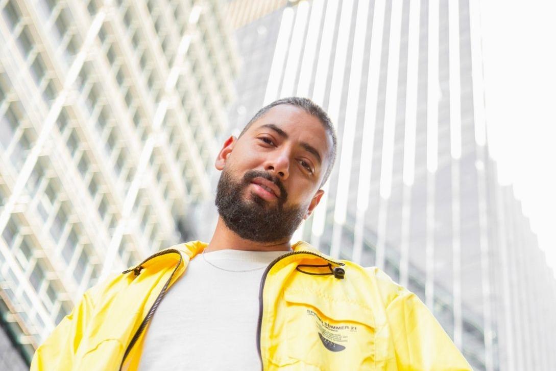 bearded man looking down the camera 