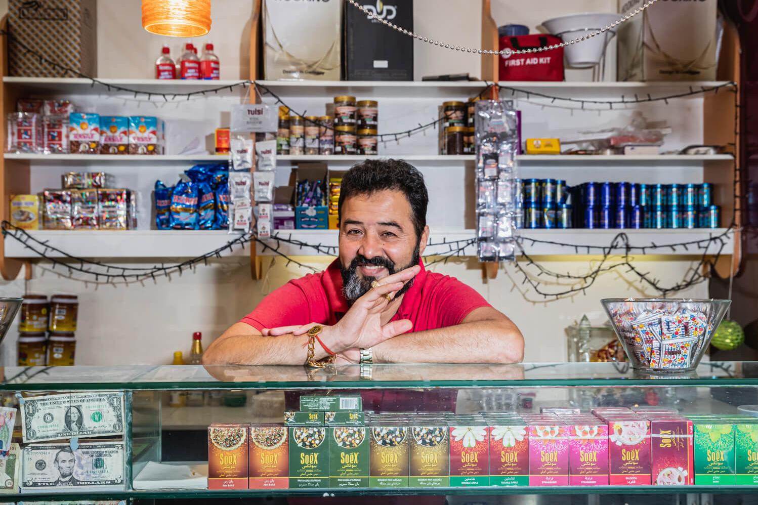 Store Owner Sitting Behind Counter